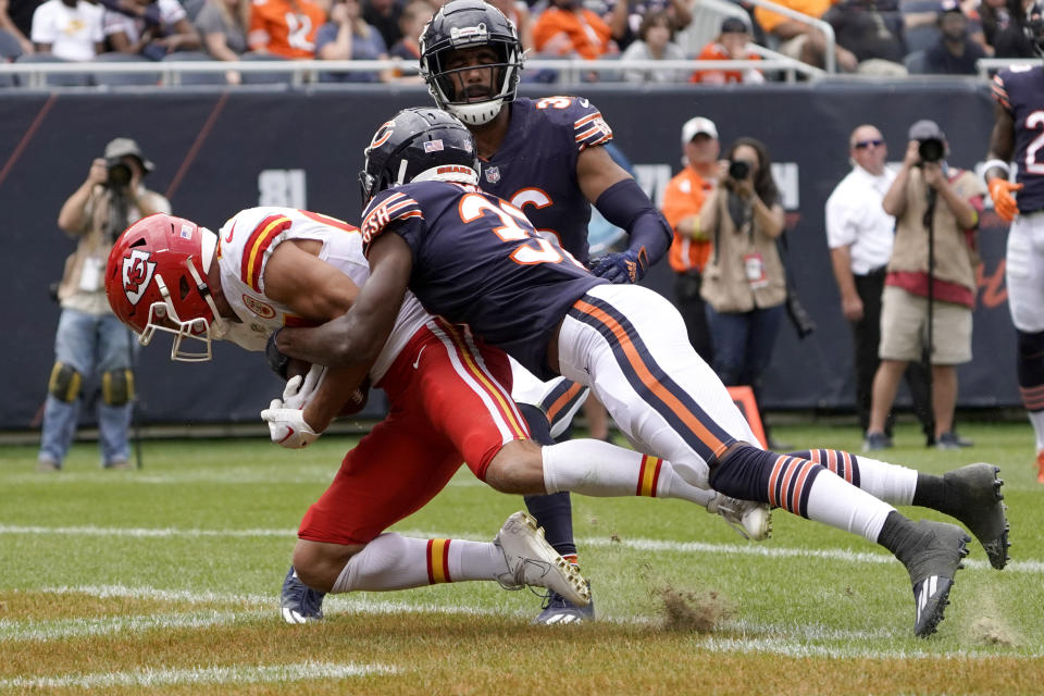 Kansas City Chiefs wide receiver Justin Watson catches a touchdown pass from quarterback Shane Buechele as Chicago Bears' Elijah Hicks defends during the first half of an NFL preseason football game Saturday, Aug. 13, 2022, in Chicago. (AP Photo/David Banks)