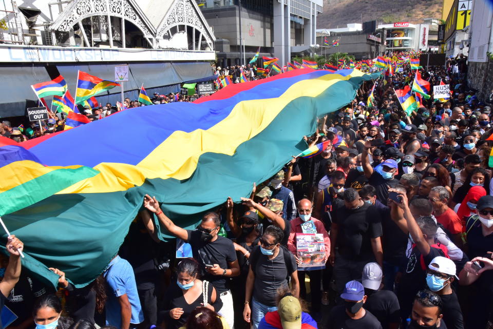 Tens of thousands of people protest in Port Louis, Mauritius, Saturday Aug. 29, 2020, over the government's slow response to an oil spill from a grounded Japanese ship and the alarming discovery of dozens of dead dolphins. (Beekash Roopun/L'express Maurice via AP)