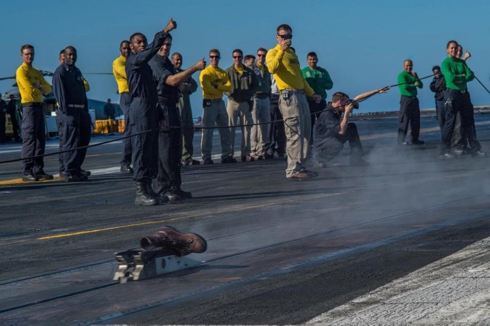 Sailors signal the catapult launch during a boot shoot