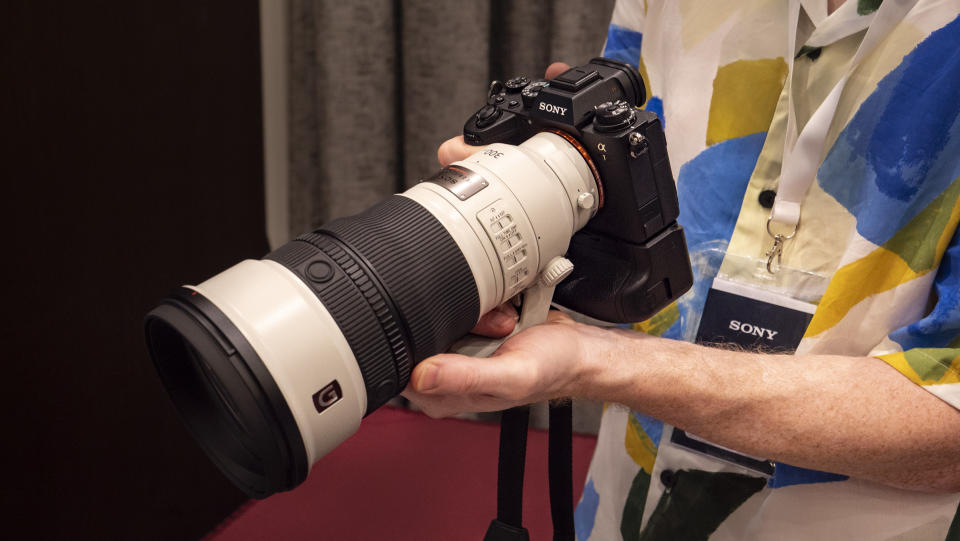 Sony FE 300mm F2.8 GM OSS lens in photographer's hands