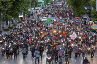 Pro-democracy supporters ride motorcycles in convoy during a demonstration in Bangkok, Thailand, Thursday, June 24, 2021. Pro-democracy demonstrators have taken to the streets of Thailand's capital again, marking the 89th anniversary of the overthrow of the country's absolute monarchy by renewing their demands that the government step down, the constitution be amended and the monarchy become more accountable. (AP Photo/Wason Wanichakorn)