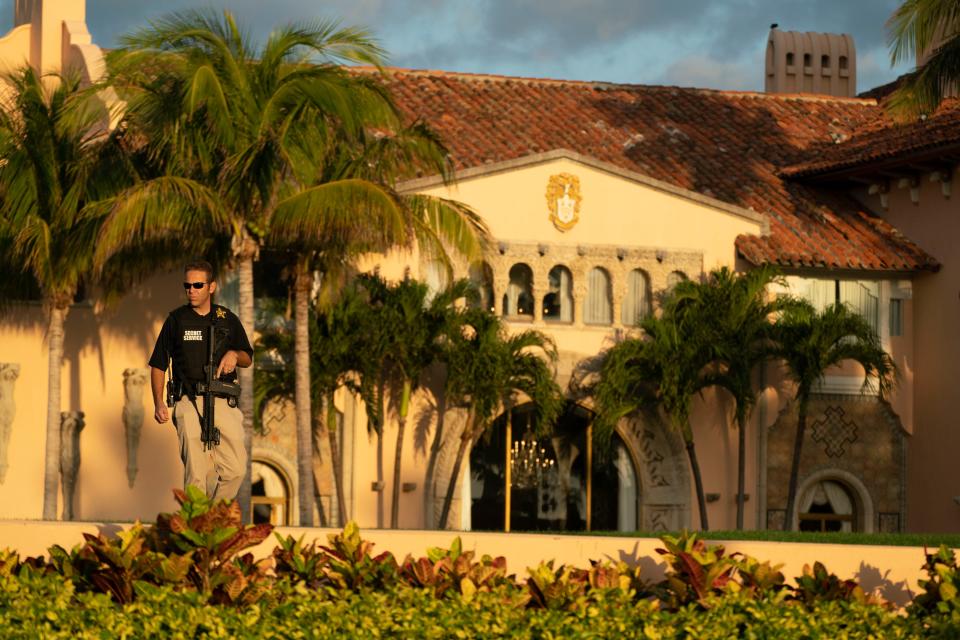 A Secret Service agent stands guard outside former president Donald Trump's Mar-a-Lago residence in Palm Beach, Fla. on March 21, 2023.
