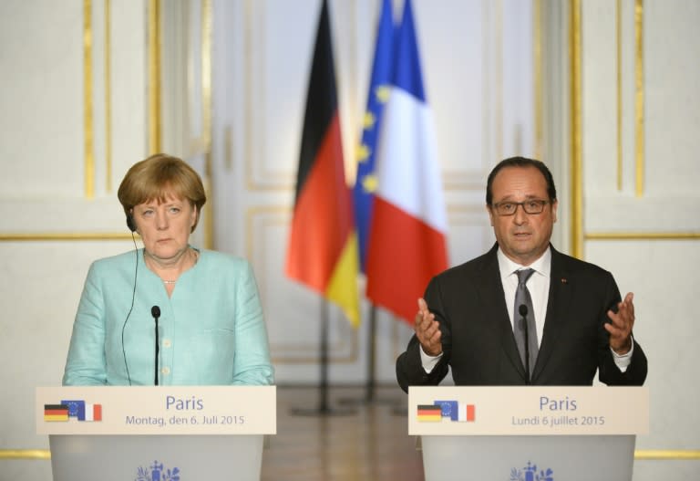 French President Francois Hollande (R) speaks during a joint press conference with German Chancellor Angela Merkel (L) at the Elysee Palace on June 6, 2015, in Paris