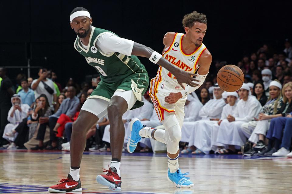 Hawks guard Trae Young dribbles past Bucks forward Bobby Portis during their preseason game Saturday at the Etihad Arena on Yas Island in Abu Dhabi.