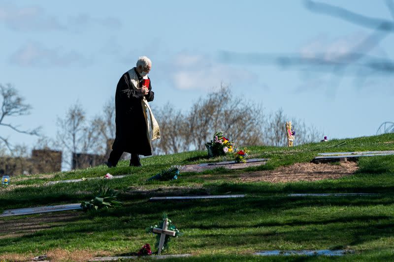 A pastor wearing a protective mask is seen at The Green-Wood Cemetery during the outbreak of the coronavirus disease (COVID-19) in the Brooklyn borough of New York City