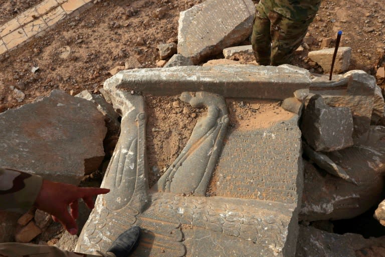 Iraqi troops point out the destruction caused by the Islamic State group at the archaeological site of Nimrud