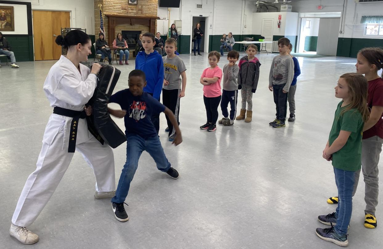 Emerson Bergmooser, left, works with 4-H members at a children’s self-defense seminar held at  the Monroe County 4-H Activity Center. Bergmooser holds a third-degree black belt in taekwondo.