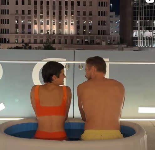 <p>Hayley Erbert/Instagram</p> Hayley Erbert and Derek Hough in an ice bath outside