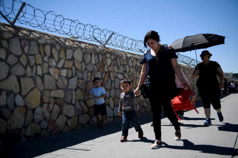 Travelers from Mexico cross a bridge leading into El Paso, Texas