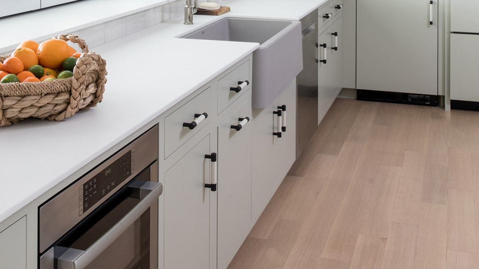 a kitchen with white cabinets and white ceiling