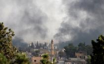 Smoke rises over the Syrian town of Tel Abyad, as seen from the Turkish border town of Akcakale