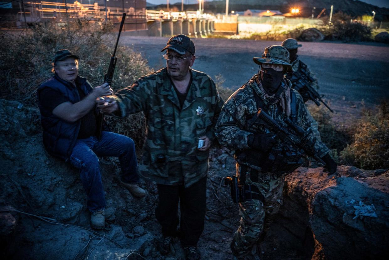 United Constitutional Patriots members Jeff Allen, Jim Benvie, "Viper" and "Stinger" take a cigarette break while patrolling the U.S.-Mexico border in Sunland Park, New Mexico, last month. (PAUL RATJE via Getty Images)