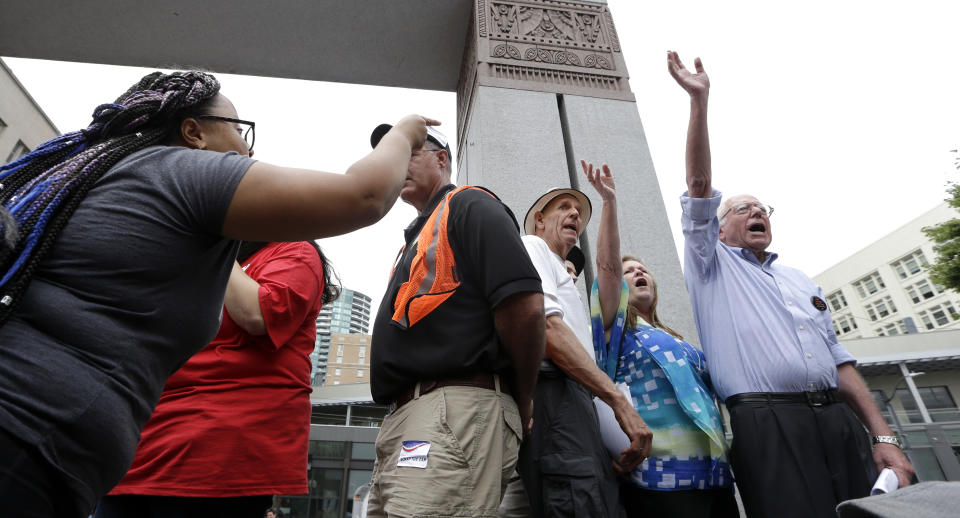 Marissa Johnson, left, of Black Lives Matter, points and yells at Sen. Bernie Sanders at a rally on Aug. 8, 2015, in downtown Seattle. (Elaine Thompson/AP)