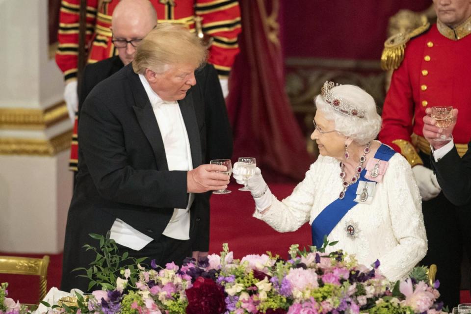 US President Donald Trump, left and The Queen make a toast during the State Banquet at Buckingham Palace (AP)