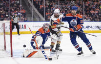 Vegas Golden Knights' Phil Kessel (8) and Edmonton Oilers' Darnell Nurse (25) and goalie Stuart Skinner (74) watch the puck during the third period of an NHL hockey game Saturday, March 25, 2023, in Edmonton, Alberta. (Jason Franson/The Canadian Press via AP)