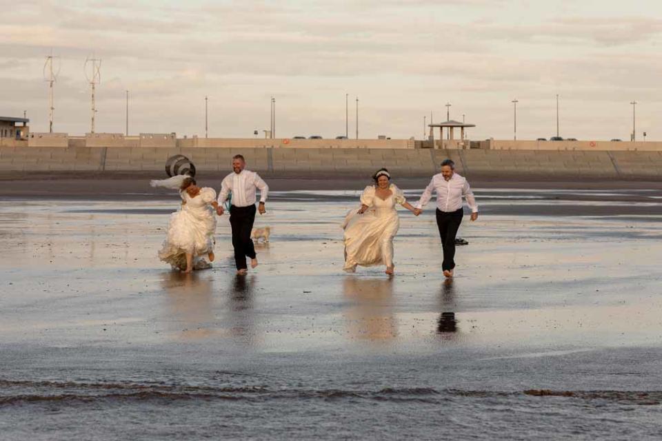 The two couples running in the sea (PA Real Life/Ashley Barnard).