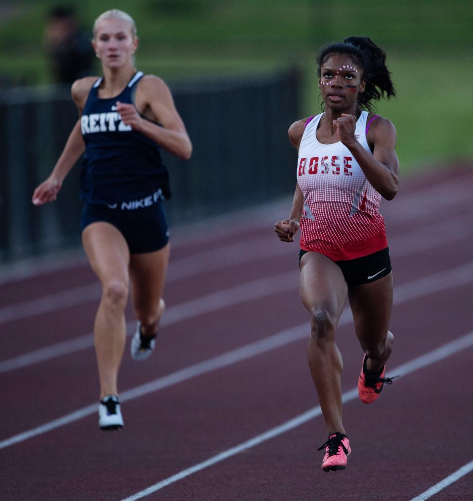 Bosse's Alexia Smith, right, and Rietz's Taylor Johnson come in first and second place respectively in the 200 meter dash at the 2023 Boys & Girls City Track & Field Meet at Central High School Monday evening, April 24, 2023.