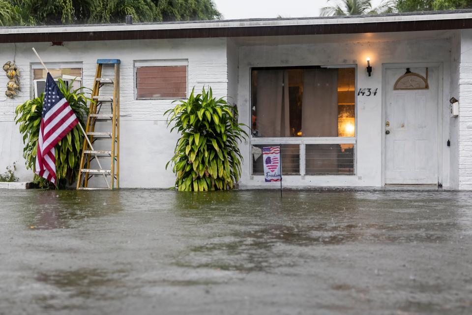 Water seeps into Sam Demarco's home as a heavy downpour floods his neighborhood on Wednesday, June 12, 2024, in Hollywood, Fla. (Matias J. Ocner/Miami Herald via AP)