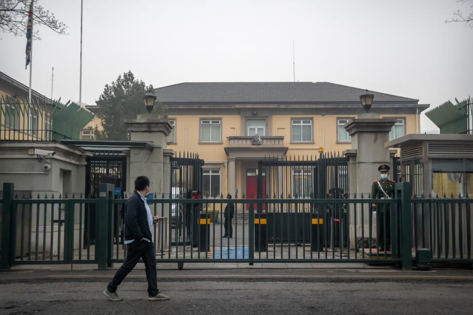 A Chinese paramilitary police officer stands guard outside the British Embassy in Beijing, Friday, March 26, 2021. China has announced sanctions on British individuals and entities following the U.K.'s joining the EU and others in sanctioning Chinese officials accused of human rights abuses in the Xinjiang region. (AP Photo/Mark Schiefelbein)