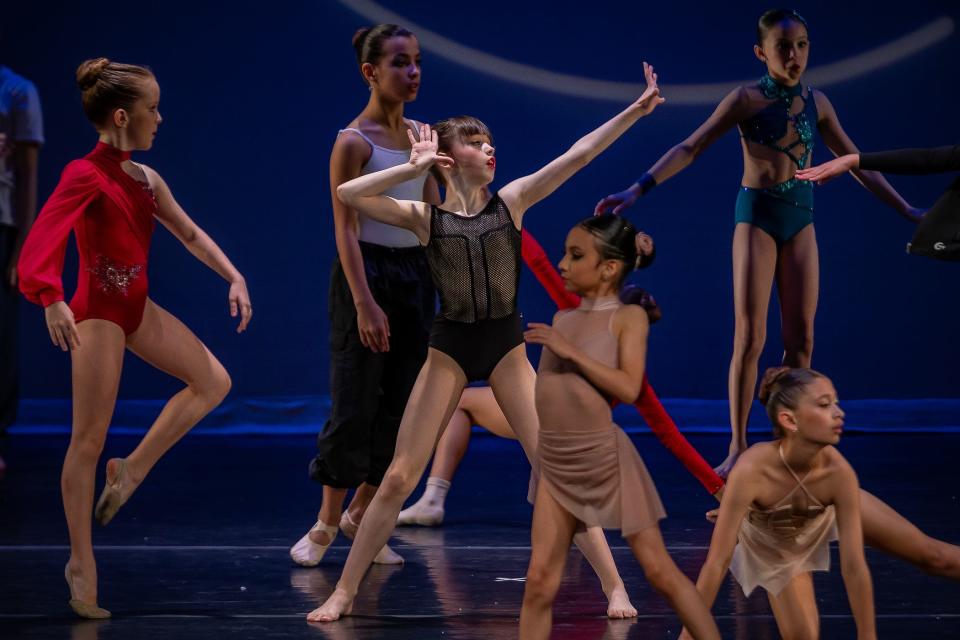 Maeve Olsen, 9, center, stretches with other dancers during open stage before the Pre-Competitive Competition Women & Men Ages 9-10 round of dancing at the Youth America Grand Prix at Countess de Hoernle Theatre at Spanish River High School.