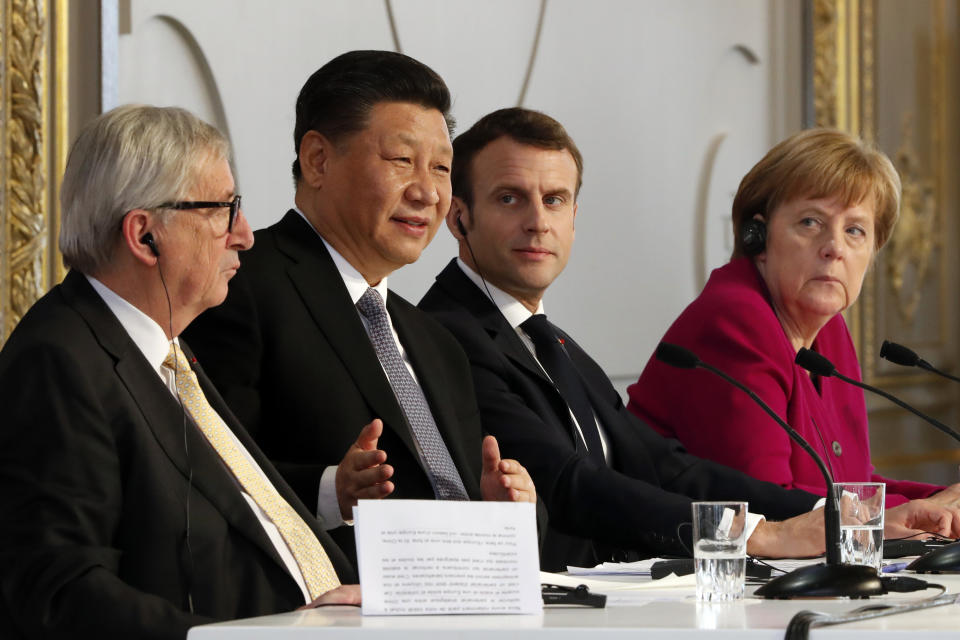 French President Emmanuel Macron, 2nd right, Chinese President Xi Jinping, German Chancellor Angela Merkel and European Commission President Jean-Claude Juncker, left, hold a press conference at the Elysee presidential palace in Paris, Tuesday, March 26, 2019. Xi Jinping is meeting with the leaders of France, Germany and the European Commission, as European countries seek to boost relations with China while also putting pressure over its trade practices. (AP Photo/Thibault Camus, Pool)