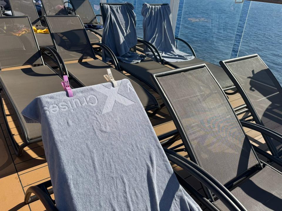 clips securing a towel to a pool chair on a cruise deck