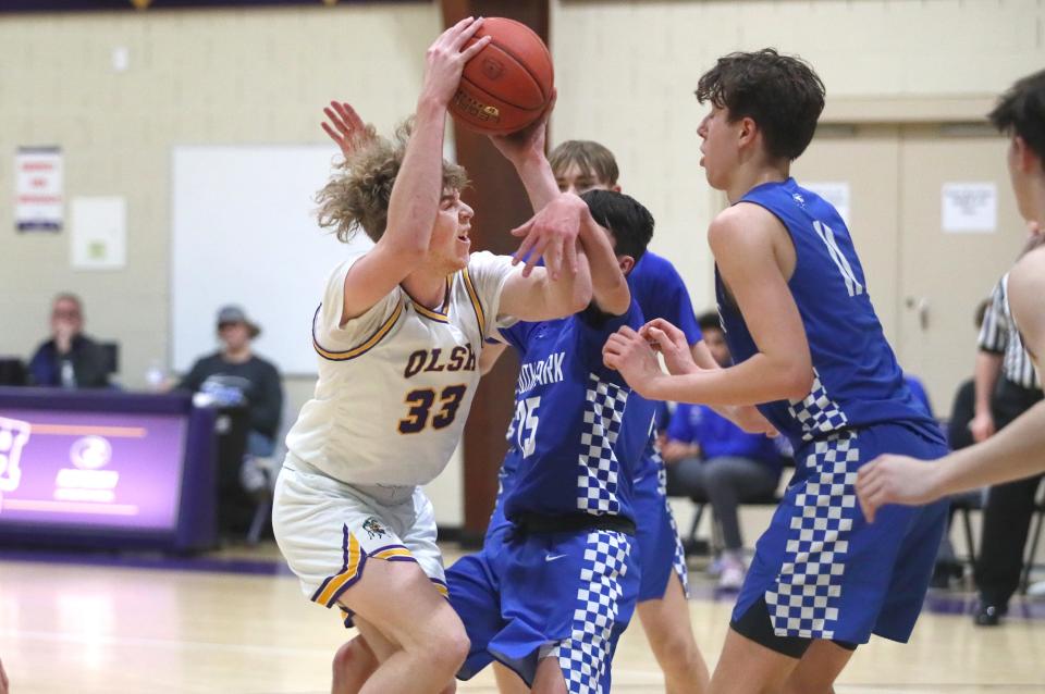 OLSH's Bryson Kirschner (33) drives to the basket around South Park's Daniel Battista (25) and Luke Scarff (11) during the first half Friday night at Our Lady of the Sacred Heart High School.