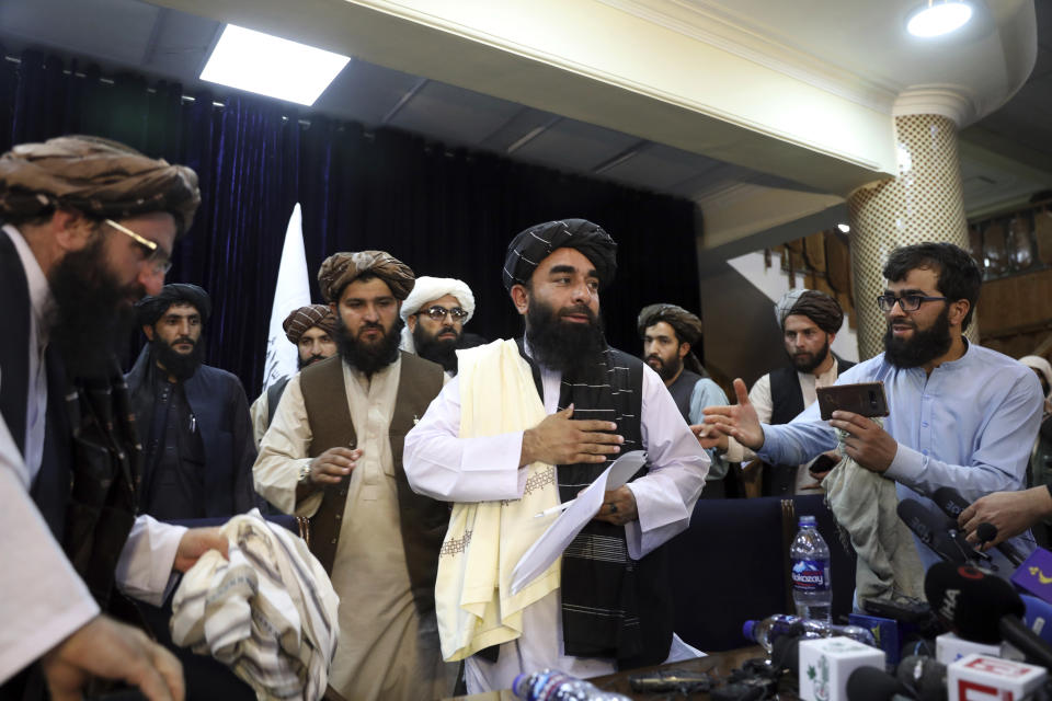 Taliban spokesman Zabihullah Mujahid, center, leaves after his first news conference, in Kabul, Afghanistan, Tuesday, Aug. 17, 2021. (Rahmat Gul/AP Photo)