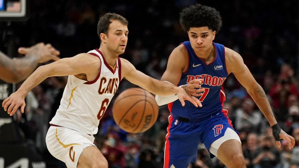 Detroit Pistons' Killian Hayes (7) and Cleveland Cavaliers' Kevin Pangos (6) battle for a loose ball in the second half of the Pistons' 98-78 loss on Friday, Nov. 12, 2021, in Cleveland.