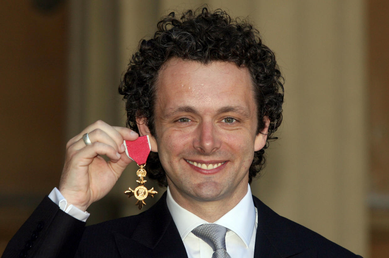 Michael Sheen with the OBE he received from Queen Elizabeth II during investitures at Buckingham Palace on June 2, 2009 in London, England. (Photo by Lewis Whyld - WPA Pool/Getty Images)