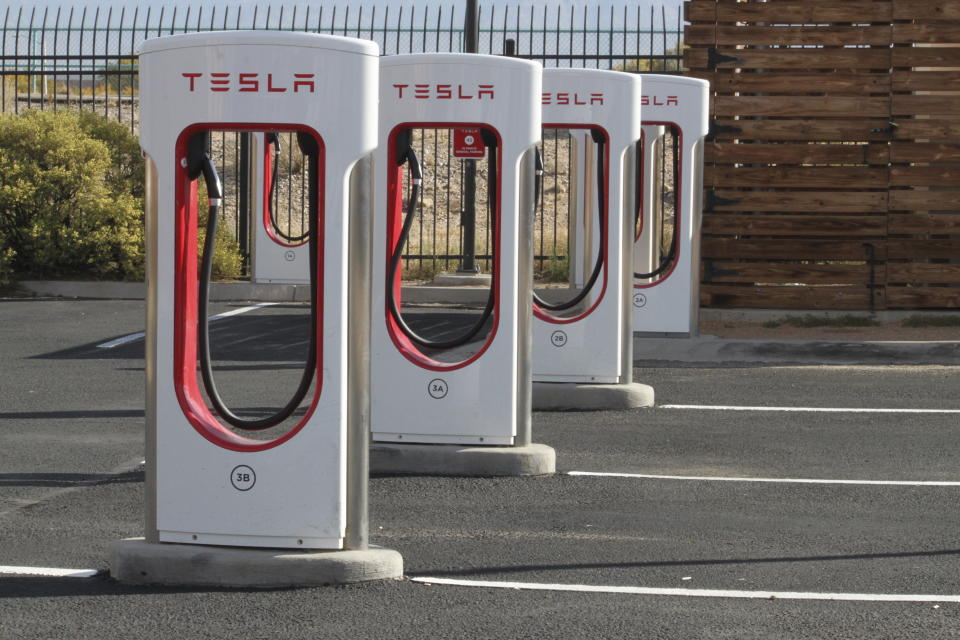 FILE - A Tesla charging station in Albuquerque, N.M., on Nov. 15, 2023. The Biden administration is awarding $623 million in grants to help build an electric vehicle charging network across the nation. Grants being announced Thursday will fund 47 EV charging stations and related projects in 22 states and Puerto Rico, including 7,500 EV charging ports. (AP Photo/Susan Montoya Bryan, File)