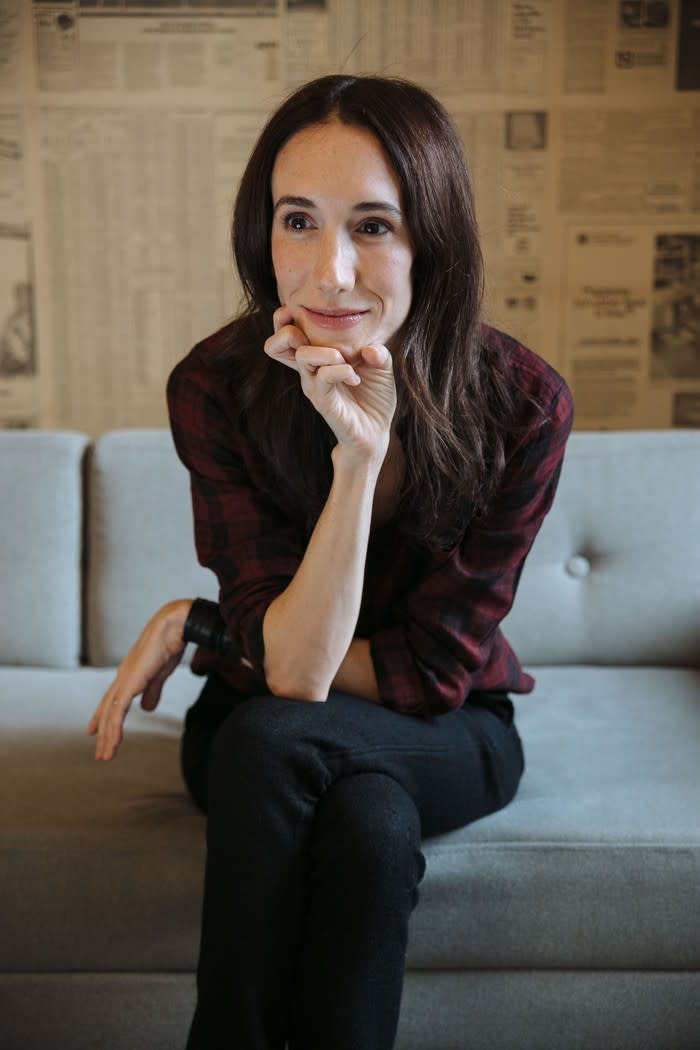 Rebekah Neumann sitting on a couch