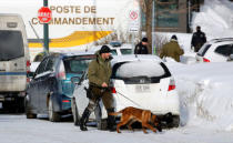 Police officers patrol the perimeter at the scene of a fatal shooting at the Quebec Islamic Cultural Centre in Quebec City, Canada. Six people were killed and eight wounded when gunmen opened fire at a Quebec City mosque during Sunday night prayers, in what Canadian Prime Minister Justin Trudeau called a "terrorist attack on Muslims". REUTERS/Mathieu Belanger