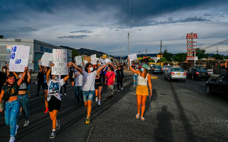 Protestors march on Central Avenue and Utah Street in Albuquerque -  The Albuquerque Journal