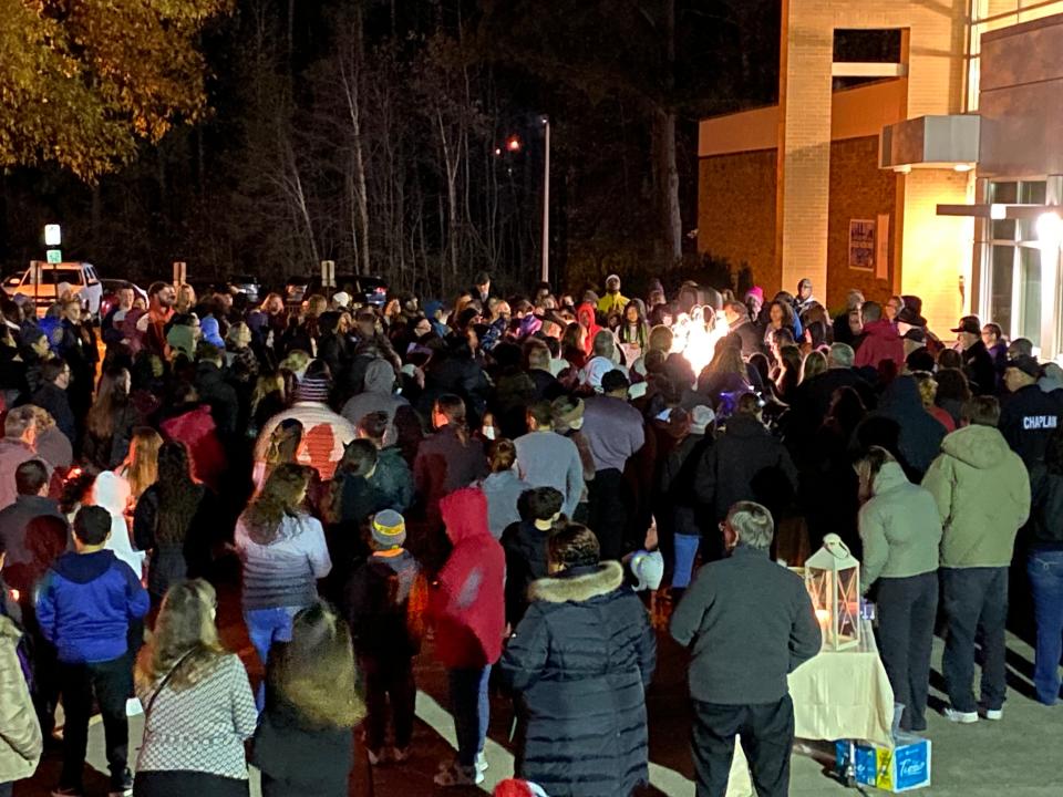 Members of the Salem Church Middle School community listen to Dr. William Gunter, pastor of Bethlehem Baptist Church, speak during a candlelight vigil Monday, Nov. 21, 2022, for four members of a Chester family shot to death Nov. 18 inside their home.