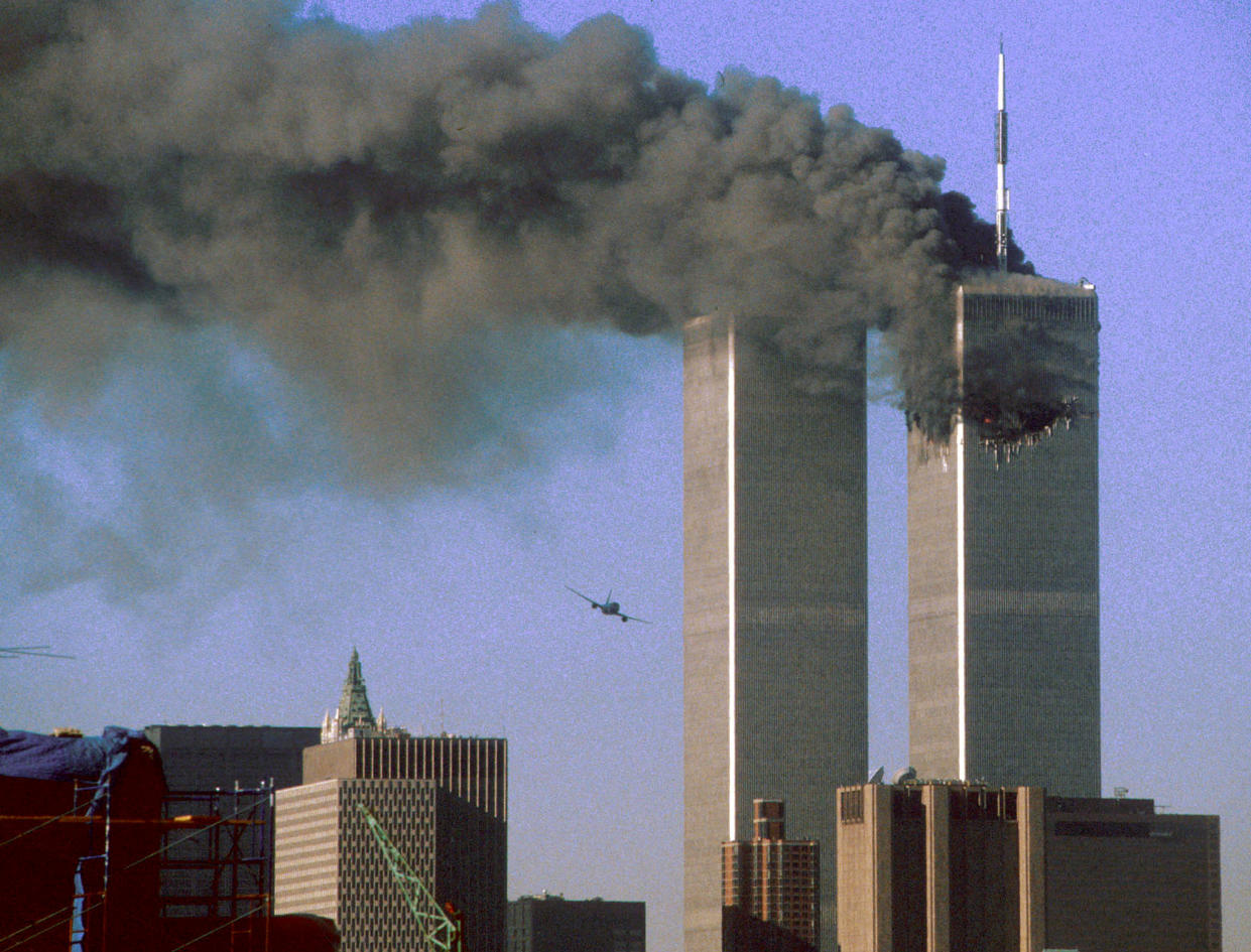 Hijacked United Airlines Flight 175 (L) flies toward the World Trade Center twin towers shortly before slamming into the south tower (L) as the north tower burns following an earlier attack by a hijacked airliner in New York City September 11, 2001. (Reuters)