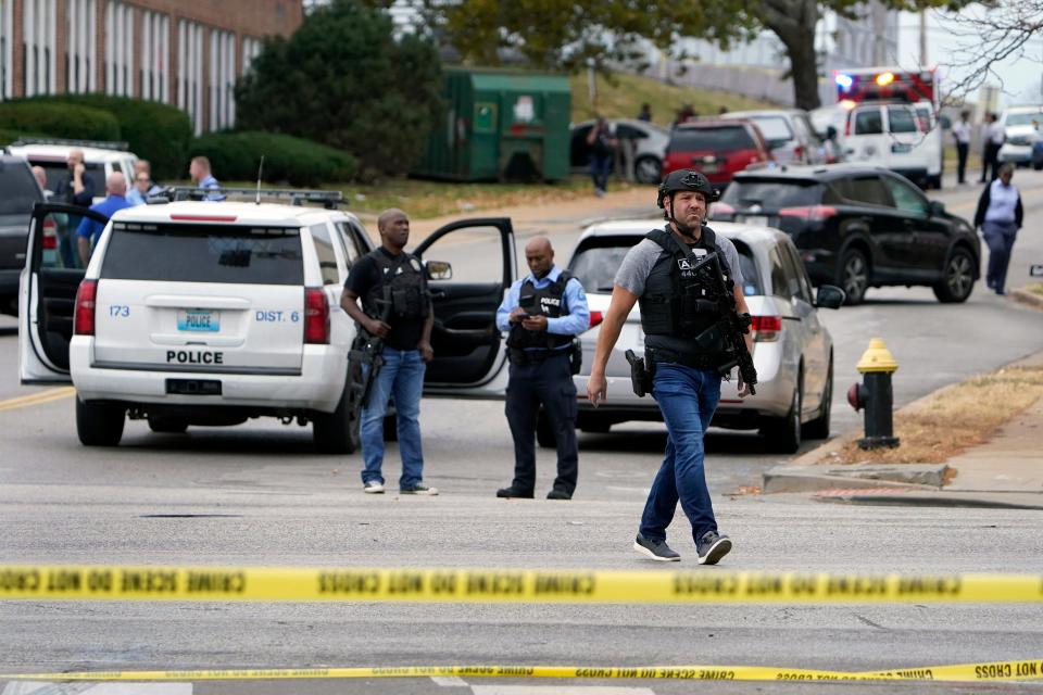 Law enforcement investigates the scene of a shooting at Central Visual and Performing Arts High School on Monday in St. Louis.