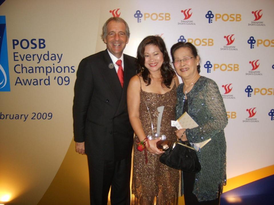 Joe Keiser, left, stands with his wife Noeline after she received a presidential award in Singapore for her involvement in community soccer.