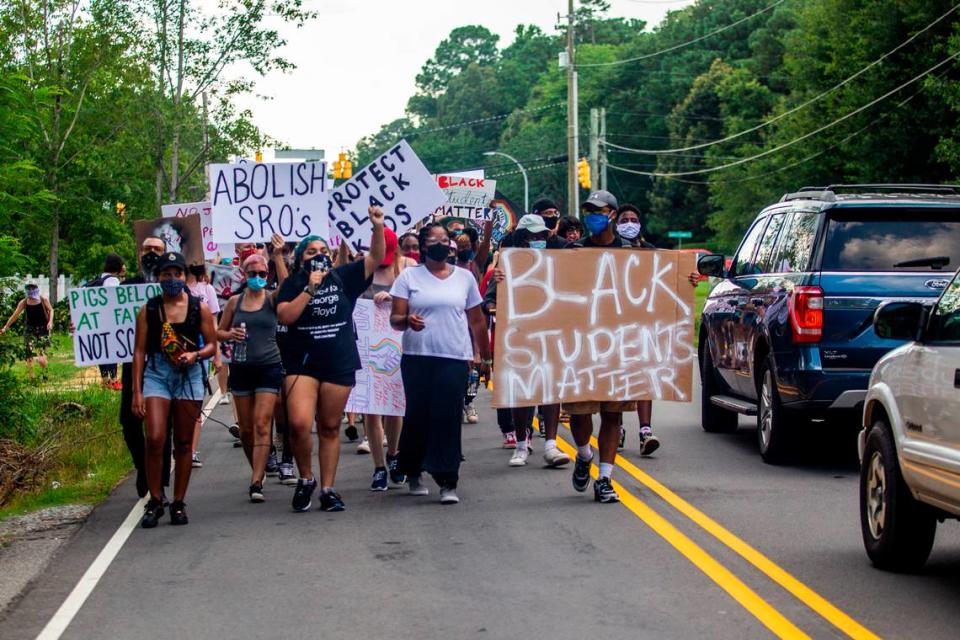 Demonstrators led by the Wake County Black Student Coalition march along Dillard Drive in Raleigh while demanding the Wake County Public School System remove the school resource officer program Tuesday, July 14, 2020. A march and sit-in coincided with a Wake County School Board meeting.