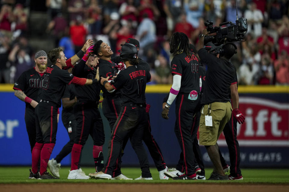 Cincinnati Reds' Noelvi Marte, center left, smiles as he celebrates with teammates after hitting a winning RBI single during the ninth inning of the second game of a baseball doubleheader against the Chicago Cubs in Cincinnati, Friday, Sept. 1, 2023. (AP Photo/Aaron Doster)