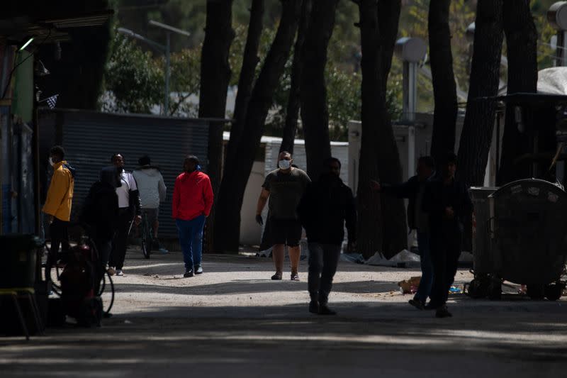 A migrant wearing a protective face mask makes his way in the Ritsona camp, after authorities found 20 coronavirus cases and placed the camp under quarantine, following the outbreak of coronavirus disease (COVID-19), in Ritsona