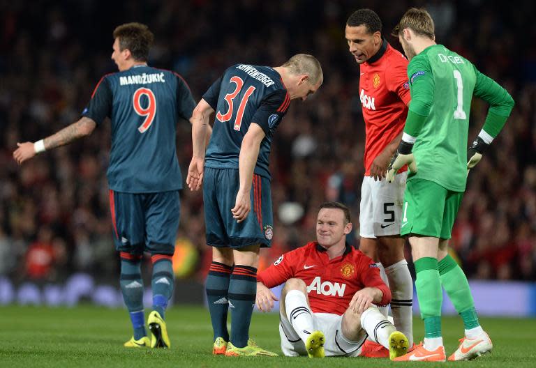 Bayern Munich's Bastian Schweinsteiger (2nd left) talks to Manchester United's Wayne Rooney (centre) during their Champions League quarter-final match at Old Trafford, on April 1, 2014