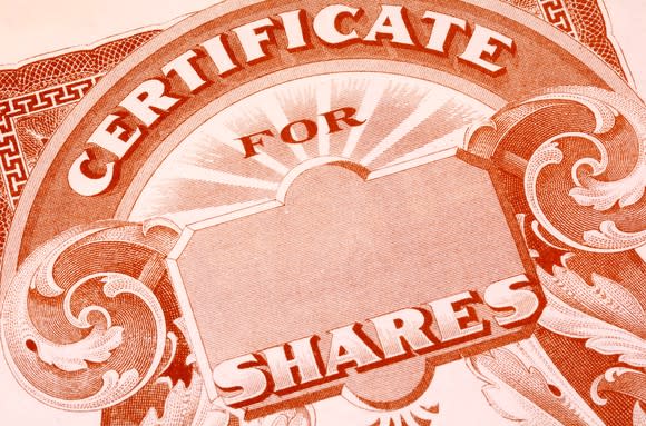 An up-close view of a paper stock certificate for publicly traded shares.