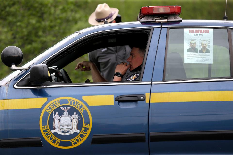 A wanted poster is displayed in the window of a state police officer's car near Dannemora, N.Y., Friday, June 12, 2015. (AP Photo/Seth Wenig)