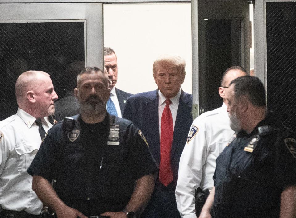 Donald Trump arrives for arraignment before Judge Juan Merchan following his surrender to New York authorities at the New York County Criminal Court on April 4, 2023. Trump appeared in court to answer charges from a grand jury investigation into payments made during the 2016 campaign to bury allegations of extramarital sexual encounters.