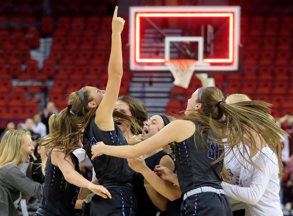 Bay Port players mob Emma Nagel (23) after winning the Division 1 championship over Middleton at the WIAA state girls basketball tournament at the Resch Center on Saturday, March 9, 2019, in Ashwaubenon.