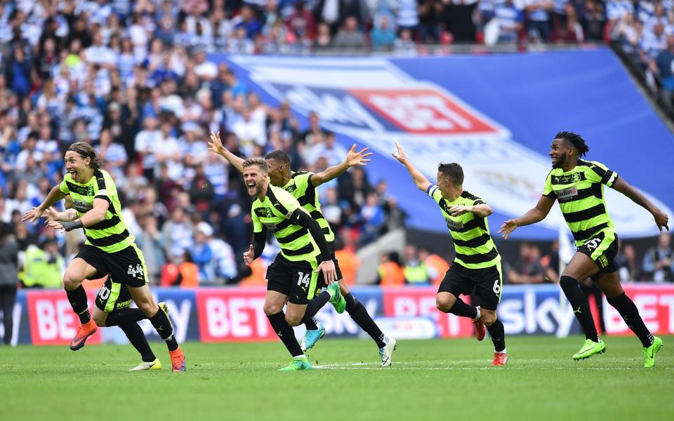 Huddersfield players celebrate after Huddersfield Town's German defender Christopher Schindler scores the final penalty - Credit: GETTY IMAGES