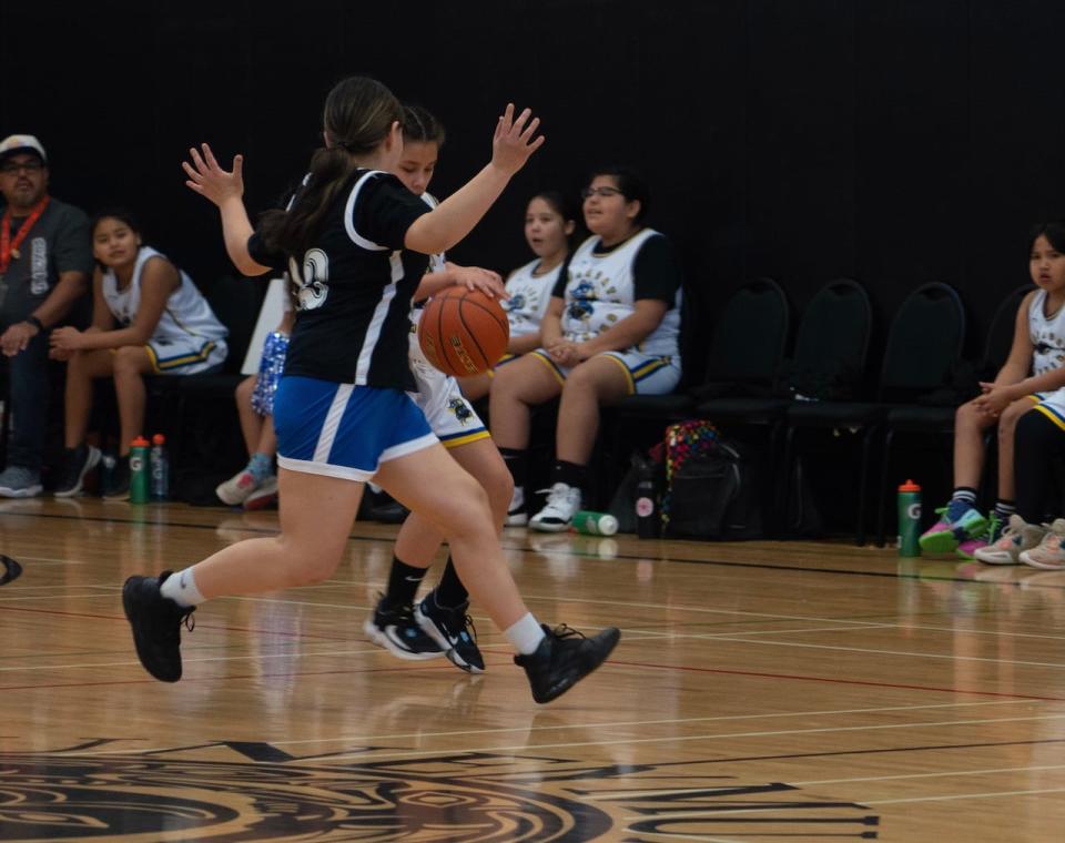 Two girls on the court at the Junior All-Native Basketball  Tournament (JANT) in Nanaimo, B.C., in 2023. 