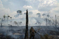 A Brazilian soldier puts out fires at the Nova Fronteira region in Novo Progresso, Brazil, on Sept. 3, 2019. (AP Photo/Leo Correa)