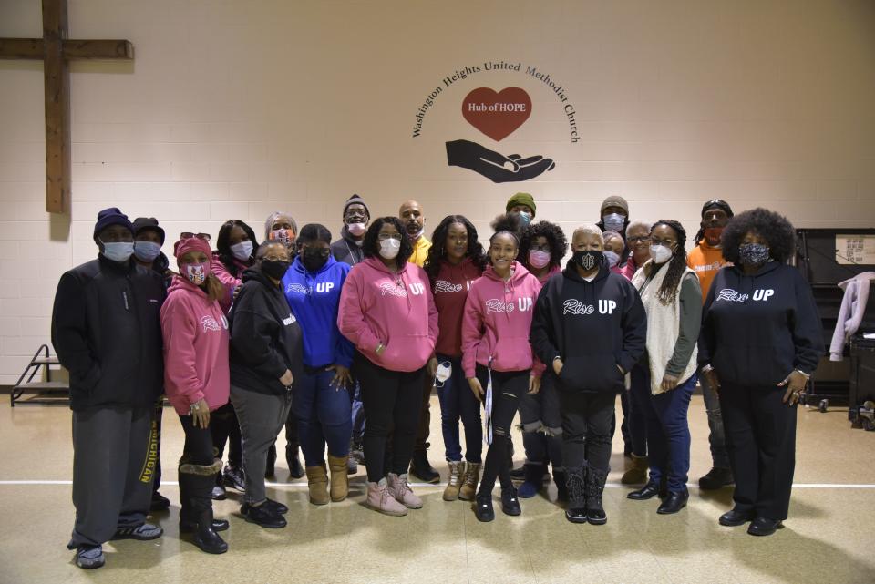 Volunteers pose for a photo at Washington Heights United Methodist Church in Battle Creek before canvassing neighborhoods to sign community members up for free Ring doorbells and subscriptions.